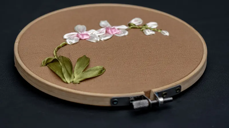 Beautiful handcrafted floral embroidery on fabric showcasing intricate floral design in an embroidery hoop