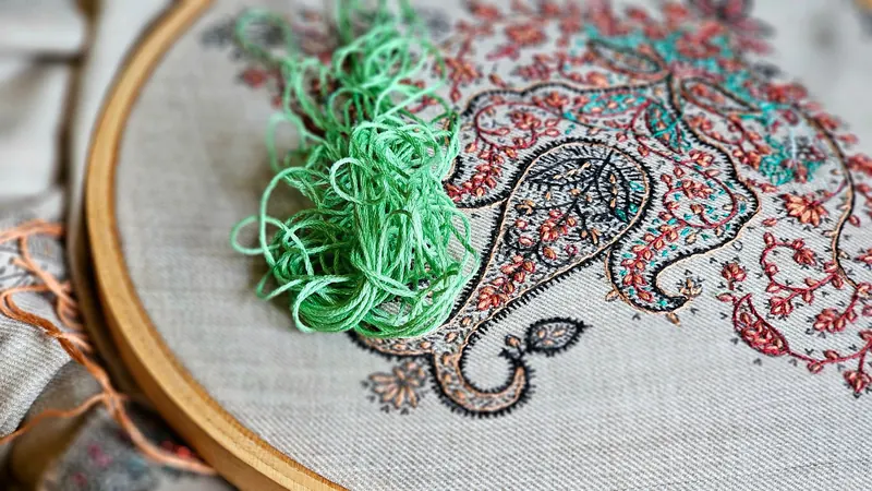 Close-up of vibrant handmade embroidery with colorful threads and wooden hoop